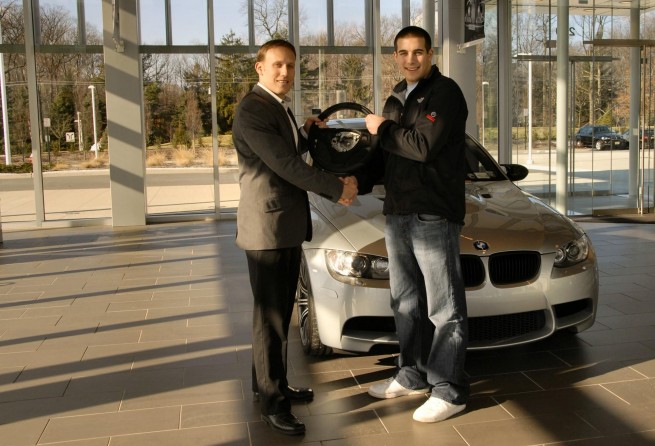 From left: Eric Riehle (BMW Performance brand manager) greets Michael Cooper at the BMW of North America Headquarters. 